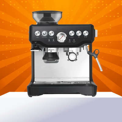 An image of a Breville Manual Coffee Machine on a white pedestal and an orange background